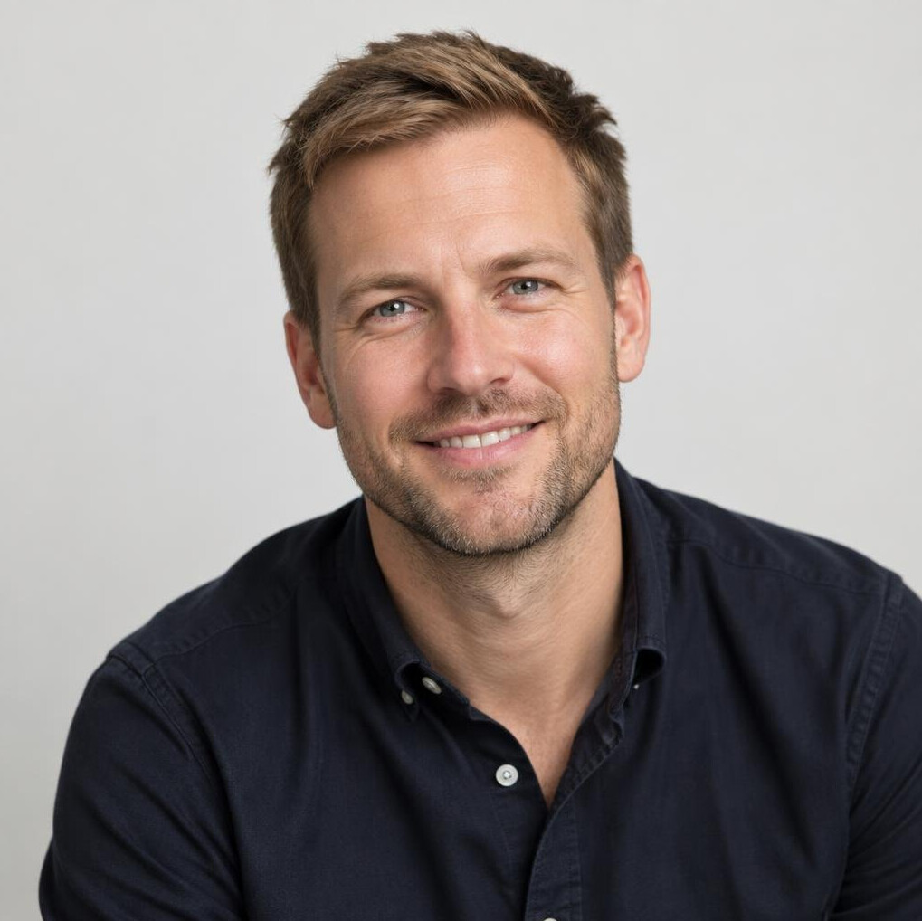Portrait of a bearded man in casual clothes smiling